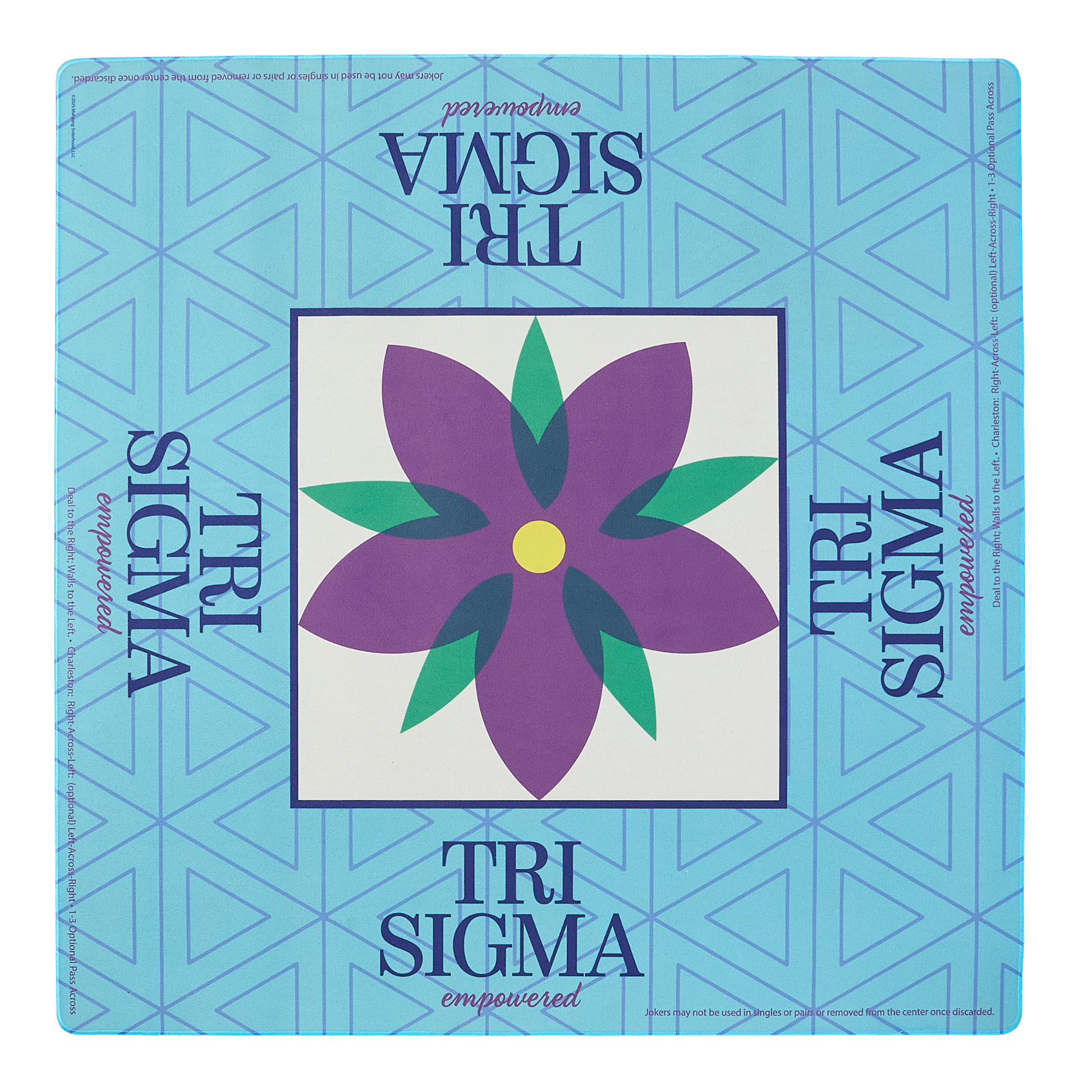 Tri Sigma mahjong mat with a purple flower design on a blue geometric patterned background
